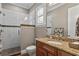 Bathroom with a granite-topped vanity, glass shower, and tiled accents at 47 Martinique Ave, Tampa, FL 33606