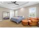 Inviting bedroom with carpet flooring, a full-length mirror, a seating area, and natural light at 47 Martinique Ave, Tampa, FL 33606