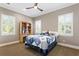 Charming bedroom featuring a cozy bed, built-in bookcase, and bright windows with plantation shutters at 47 Martinique Ave, Tampa, FL 33606