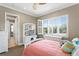 Bedroom featuring a white desk, bright windows with plantation shutters, and cozy decor at 47 Martinique Ave, Tampa, FL 33606
