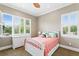 Cozy bedroom featuring bright windows with plantation shutters, a white bed frame, and neutral decor at 47 Martinique Ave, Tampa, FL 33606