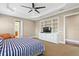 Bright bedroom featuring built-in storage, a tray ceiling, and a comfortable seating area at 47 Martinique Ave, Tampa, FL 33606