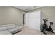Versatile bonus room featuring a sofa, murphy bed and workout equipment for recreation and fitness at 47 Martinique Ave, Tampa, FL 33606