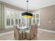 Elegant dining room featuring a glass table, seating for six, and bright windows with shutters at 47 Martinique Ave, Tampa, FL 33606