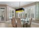 Elegant dining room featuring a glass table, seating for six, and bright windows with shutters at 47 Martinique Ave, Tampa, FL 33606