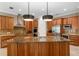 Bright kitchen featuring custom cabinets, granite counters, stainless steel appliances, and an island with sink at 47 Martinique Ave, Tampa, FL 33606