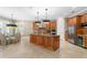 Open-concept kitchen with an island, granite countertops, stainless steel appliances and adjacent dining area at 47 Martinique Ave, Tampa, FL 33606