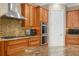 Close up on kitchen granite counters, stainless steel appliances, wooden cabinets and tile backsplash at 47 Martinique Ave, Tampa, FL 33606