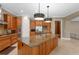 Bright kitchen featuring custom cabinets, granite counters, stainless steel appliances, and an island with sink at 47 Martinique Ave, Tampa, FL 33606