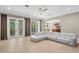 Spacious living room with large sectional sofa, tile floors, ceiling fan, and double doors that lead to the pool at 47 Martinique Ave, Tampa, FL 33606