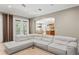 Open-concept living space featuring a large gray sectional sofa, tile flooring, and views into the kitchen at 47 Martinique Ave, Tampa, FL 33606