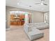 Bright living room featuring a large sectional sofa and an open layout leading to the kitchen at 47 Martinique Ave, Tampa, FL 33606