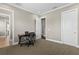 Carpeted office features a desk with a chair and a view of a doorway to another room at 47 Martinique Ave, Tampa, FL 33606