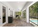 Screened-in patio with brick flooring, an outdoor kitchen area, and a beautiful pool view at 47 Martinique Ave, Tampa, FL 33606