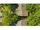 Aerial view of the backyard and home surrounded by lush landscaping at 5245 Lochmead Ter, Zephyrhills, FL 33541