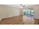 This cozy bedroom features sleek floors and sliding glass doors to the screened patio at 5245 Lochmead Ter, Zephyrhills, FL 33541