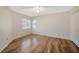 Bedroom with wood floors, neutral walls, and abundant natural light at 5245 Lochmead Ter, Zephyrhills, FL 33541