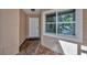 Welcoming front entrance with brick flooring, a white door, and a view of the sunny exterior at 5245 Lochmead Ter, Zephyrhills, FL 33541