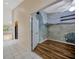 Hallway featuring tile floors leading to the living room and bedroom with unique mural at 5245 Lochmead Ter, Zephyrhills, FL 33541