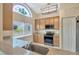 Well-lit kitchen features granite countertops, wood cabinets, stainless steel appliances, and a decorative window at 5245 Lochmead Ter, Zephyrhills, FL 33541