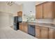 Kitchen featuring sleek black appliances, granite countertops, and tiled floors, perfect for cooking at 5245 Lochmead Ter, Zephyrhills, FL 33541