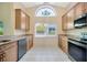 Well-lit kitchen featuring granite countertops, modern appliances, and ample cabinet space at 5245 Lochmead Ter, Zephyrhills, FL 33541