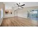 Open-concept living area flows to a sunroom and features updated flooring and modern lighting at 5245 Lochmead Ter, Zephyrhills, FL 33541