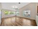 Spacious living room boasts wood floors, high ceilings, and large windows offering ample natural light at 5245 Lochmead Ter, Zephyrhills, FL 33541