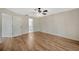 Main bedroom showcases an ensuite bathroom, wood floors, and modern lighting at 5245 Lochmead Ter, Zephyrhills, FL 33541
