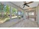 Bright sunroom with ceiling fan and several windows to enjoy the outside view at 5245 Lochmead Ter, Zephyrhills, FL 33541