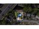 An aerial view displays the home within property lines, surrounded by lush greenery and a nearby road at 5444 70Th N Ln, St Petersburg, FL 33709
