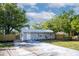 Inviting single-story home features a new driveway, metal roof, and manicured landscaping, enhancing its appeal at 5444 70Th N Ln, St Petersburg, FL 33709