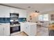 Open-concept kitchen seamlessly connects to the living room, featuring modern appliances and stylish accents at 5444 70Th N Ln, St Petersburg, FL 33709