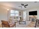 Bright living room featuring hardwood floors, neutral tones, and a comfortable seating arrangement for relaxation at 5444 70Th N Ln, St Petersburg, FL 33709
