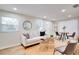 Bright living room featuring a neutral color palette, decorative rug, and a stylish round mirror accent at 5444 70Th N Ln, St Petersburg, FL 33709