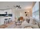 Cozy living room features modern decor, a ceiling fan, and a seamless transition to the adjacent updated kitchen at 5444 70Th N Ln, St Petersburg, FL 33709