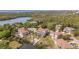Panoramic aerial view of a home with a screened-in pool, waterfront access, and lush surroundings at 7345 Brightwaters Ct, New Port Richey, FL 34652