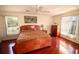 Bedroom features hardwood floors and two windows with natural light at 7345 Brightwaters Ct, New Port Richey, FL 34652