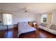 Spacious bedroom with ceiling fan, wood floors, lots of natural light, and space for seating at 7345 Brightwaters Ct, New Port Richey, FL 34652