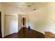 Simple bedroom with hardwood floors, white walls, and a closet, offering a clean and versatile space at 7345 Brightwaters Ct, New Port Richey, FL 34652