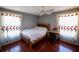 Cozy bedroom with hardwood floors, natural light, and a desk area, creating a comfortable living space at 7345 Brightwaters Ct, New Port Richey, FL 34652