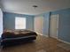 This bedroom is painted in light blue and features a full-sized bed and sliding glass doors to the outside at 7345 Brightwaters Ct, New Port Richey, FL 34652