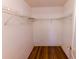 Walk-in closet featuring laminate floors and metal shelving for optimal storage and organization at 7345 Brightwaters Ct, New Port Richey, FL 34652