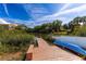 Dock on lake featuring a boat, seating, and lush green vegetation at 7345 Brightwaters Ct, New Port Richey, FL 34652