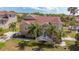 Beautifully landscaped home with mature palm trees, inviting stairway and an attractive, neutral color scheme at 7345 Brightwaters Ct, New Port Richey, FL 34652