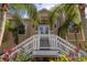 Home exterior featuring a grand staircase leading to a welcoming covered front entrance at 7345 Brightwaters Ct, New Port Richey, FL 34652