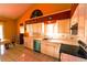 Well-lit kitchen featuring white cabinets, tiled countertops, stainless steel appliances, and tiled floors at 7345 Brightwaters Ct, New Port Richey, FL 34652