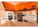 Open kitchen featuring tiled countertops and floors, stainless steel appliances, and ample cabinet space at 7345 Brightwaters Ct, New Port Richey, FL 34652