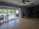 A living room view highlighting access to an outdoor pool area with sliding glass doors at 7345 Brightwaters Ct, New Port Richey, FL 34652