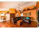 Spacious living room featuring hardwood floors, a large sectional sofa, and an open floor plan to the dining area at 7345 Brightwaters Ct, New Port Richey, FL 34652